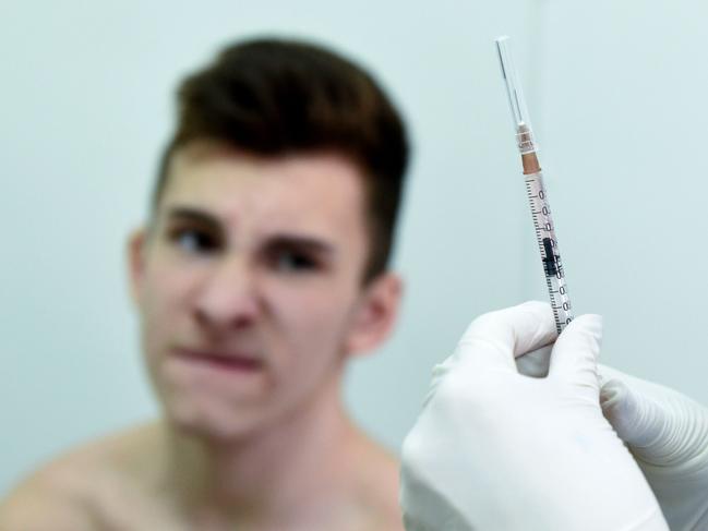 TOPSHOT - A nurse prepares a measles vaccine to a boy in the school of Lapaivka village near the western Ukrainian city of Lviv on February 21, 2019. - The mobile brigade, which consists of two pediatricians and a nurse, arrived to the Lapaivka village as part of the health ministry's special operation in this region, leading in terms of registered measles cases. A measles epidemic is still not declared in Ukraine, though in 2018 the country recorded highest number of measles cases in European region. Since the start of 2019, around 20,000 people in Ukraine have contracted this highly contagious viral disease. Nine people, including two children, have died of measles in Ukraine this year. (Photo by Yuri DYACHYSHYN / AFP)