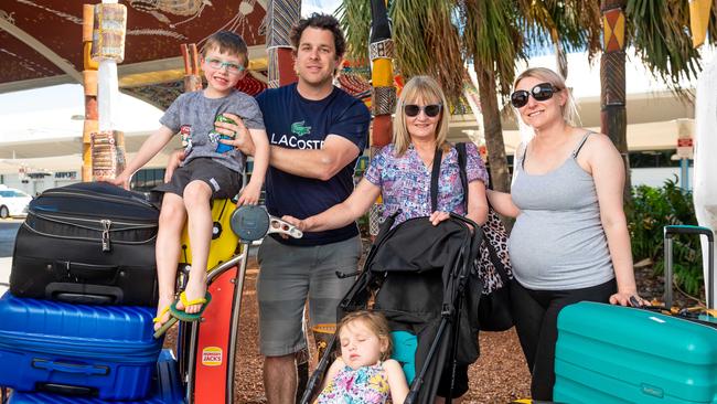 Troy Foster, 5, Matt Foster, Susan Bennett, Hayley Foster and (sleeping) Alex Foster, 3 flew into Darwin International Airport yesterday. They have recently relocated to Darwin from WA and SA. Picture: Che Chorley