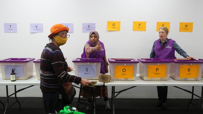 Members of the public attend an early polling centre in Sydney.