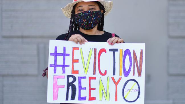 Yudy Ramirez, 46, who got laid off from her job in March and is unable to pay rent holds up a sign, during a protest against evictions and in support of the movement to "cancel rent" in the Bronx borough of New York City. Picture: Angela Weiss/AFP)