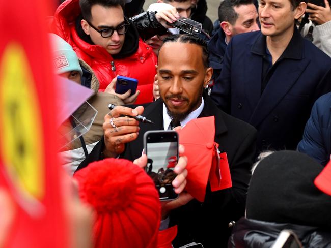 FIORANO MODENESE, ITALY - JANUARY 20: Sir Lewis Hamilton greets fans during his first official days as a Scuderia Ferrari F1 driver at Fiorano Circuit as John Elkann, CEO of Exor, looks on, on January 20, 2025 in Fiorano Modenese, Italy.  (Photo by Rudy Carezzevoli/Getty Images) *** BESTPIX ***