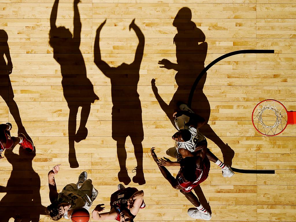 “2015 NCAA Tournament” by photographer Greg Nelson for Sports Illustrated which won second prize in the Sports Singles category shows the National Collegiate Athletic Association (NCAA) 2015 Mens Basketball Tournament game with Wichita State vs. Indiana, Ron Baker shoots over Nick Zeisloft whilst Hanner Mosquera-Perea and Rashard Kelly battle for position at the CenturyLink Center in Omaha, Nebraska, USA, on March 20, 2015.(Greg Nelson/Sports Illustrated, World Press Photo via AP)