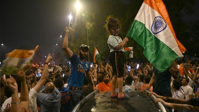 Fans hold Indian national flags as they celebrate India's victory at the 2024 ICC men's Twenty20 World Cup in New Delhi. Picture: AFP