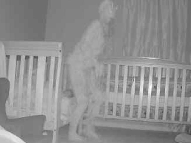 ONE TIME WEB USE ONLY - FEES APPLY FOR REUSE -  PIC FROM Kennedy News and Media (PICTURED: FOOTAGE OF THE 'DEMON' IN TORY MCKENZIE'S GRANDCHILDREN'S ROOM) A terrified grandma is begging for help after capturing 'a demon' standing over her grandchild's bed - just days after the tot was heard warning an invisible intruder to 'go away'. Tory McKenzie set up a motion-activated camera at her son's house after complaints his two-year-old daughter Amber McKenzie was talking to something unseen in the middle of the night. The 41-year-old checked her camera's app four days later to find a bone-chilling image of a figure standing inches away from the sleeping tot and her seven-month-old brother Michael McKenzie, with 'a horn on its head and long claws'. DISCLAIMER: While Kennedy News and Media uses its best endeavours to establish the copyright and authenticity of all pictures supplied, it accepts no liability for any damage, loss or legal action caused by the use of images supplied and the publication of images is solely at your discretion. SEE KENNEDY NEWS COPY - 0161 697 4266  Picture: Kennedy News