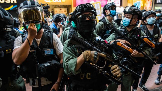 Riot police clear a street as protesters rally against a new national security law in Hong Kong. Picture: AFP