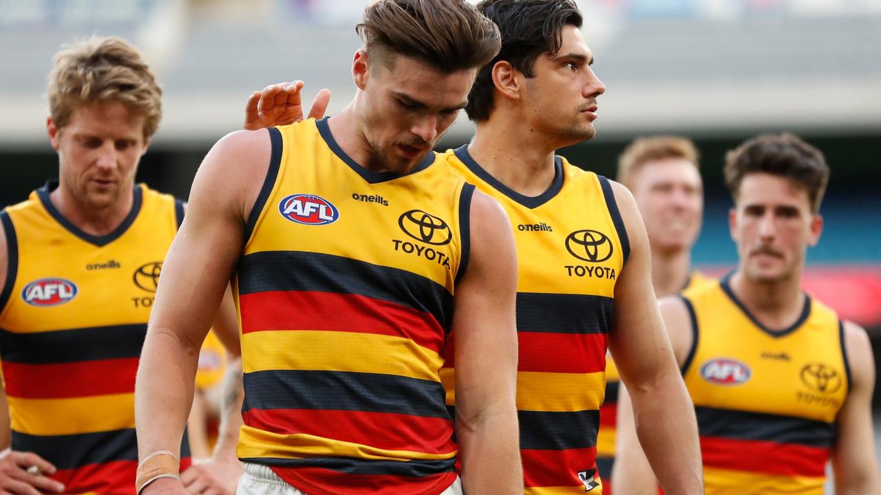 MELBOURNE, AUSTRALIA – AUGUST 15: Ben Keays (L) and Shane McAdam of the Crows react after a loss during the 2021 AFL Round 22 match between the Melbourne Demons and the Adelaide Crows at the Melbourne Cricket Ground on August 15, 2021 in Melbourne, Australia. (Photo by Michael Willson/AFL Photos via Getty Images)