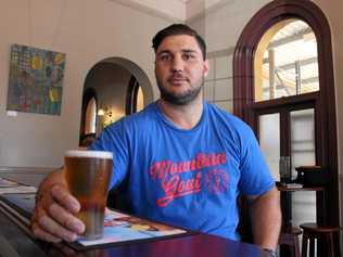 Manager and hotel owner Darren Pettiford at the Warwick Hotel with a schooner of beer in hand. Picture: Marian Faa