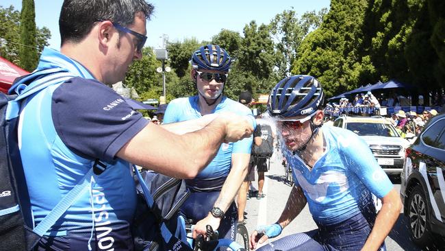 Movistar riders Jasha Sutterlin, left, and Nuno Matos, right, try to beat the heat after yesterday’s stage 2 of the Tour Down Under. Picture SARAH REED