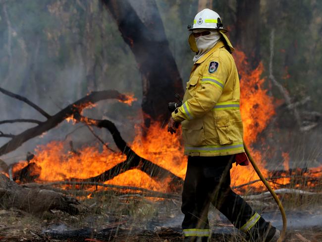 Daily Telegraph. Bushfires. RFS Volunteers put in a backburn to help fight the out of control bushfire at Gilgai near Inverell in northern NSW. Pic Nathan Edwards