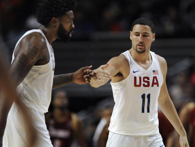 Klay Thompson (11) celebrates with DeAndre Jordan during a warm-up game.