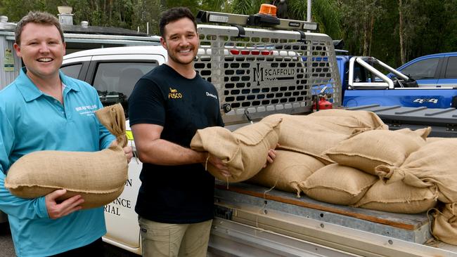 Cungulla residents prepare for Cyclone Kirrily. Division 10 candidate Brady Ellis with Division 10 Cr Ben Fusco with sandbags at the community hall, demonstrating a cheerful vibe between the two even though they campaigned against each other. Picture: Evan Morgan