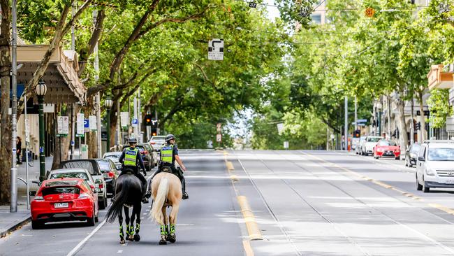 Police patrol by horseback on Collins Street, Melbourne. Picture: Tim Carrafa