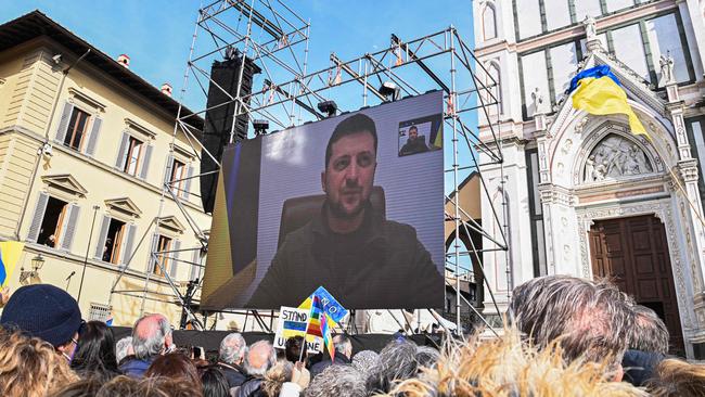 A giant screen in Florence, Tuscany, displays an image of Ukraine's President Volodymyr Zelensky speaking through a video link. Picture: AFP