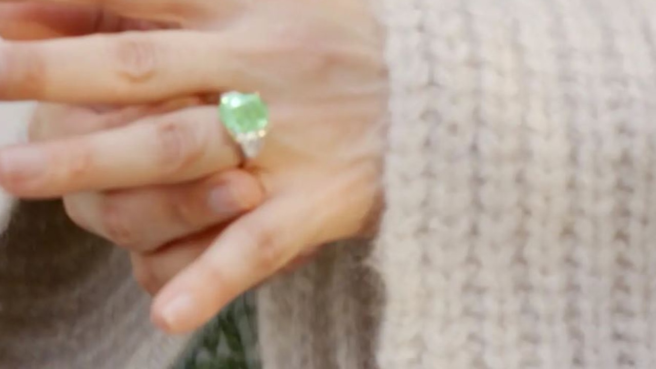 The ring is 8.5-carat rare green diamond flanked by a matching pair of trapezoid-shaped white diamonds.