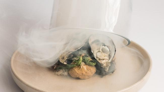 Smoked oysters are theatrically presented under a cloche of apple wood smoke. Pictures: Joanne O'Keefe