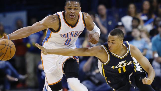 Oklahoma City Thunder guard Russell Westbrook (0) steals the ball from Utah Jazz guard Dante Exum (11) during the first quarter of a preseason NBA basketball game in Oklahoma City, Tuesday, Oct. 21, 2014. (AP Photo/Sue Ogrocki)