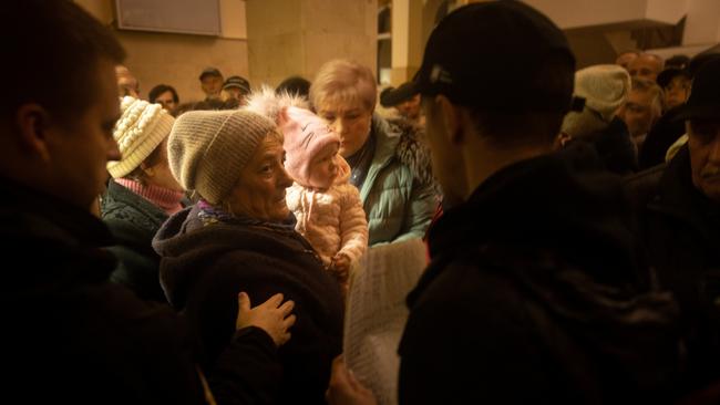 People prepare to board an evacuation train after their names were called out from a passenger list. Picture: Getty Images.