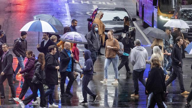 BRISBANE AUSTRALIA - NewsWire NCA Photos JULY 5, 2022: Queenslanders rug up as heavy rain and colder than average temperatures hit Brisbane today. NewsWire / Sarah Marshall