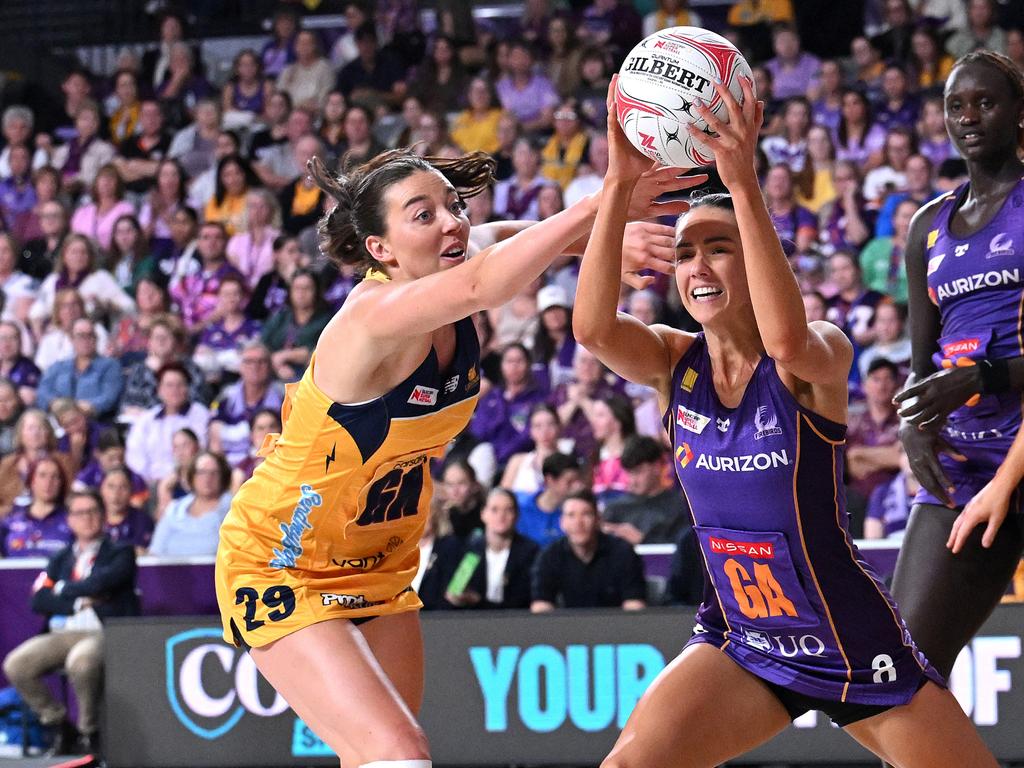 Emily Moore holds on to the ball under pressure from Lightning’s Ashleigh Ervin. Picture: Getty Images