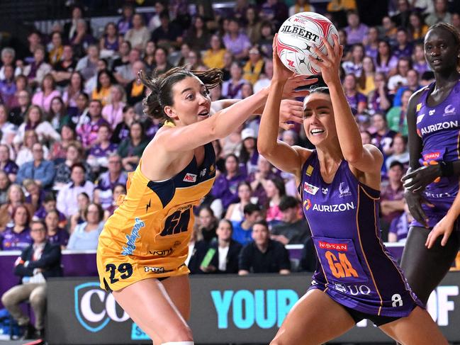 Emily Moore holds on to the ball under pressure from Lightning’s Ashleigh Ervin. Picture: Getty Images