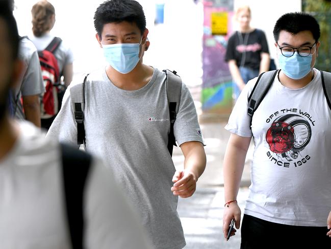 People wearing masks in Brisbane CBD for the Coronavirus. Thursday March 19, 2020. (AAP image, John Gass)