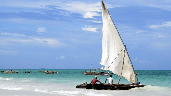 Fishermen and their dhow on Zanzibar, Tanzania.