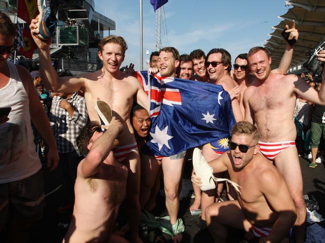UPLOADED IMAGE - In this Sunday, Oct. 2, 2016 photo, Australian men pose for a photo in Budgy Smuggler-brand swimsuits decorated with the Malaysian flag at the conclusion of the Malaysian Formula One Grand Prix in Sepang, Malaysia. Malaysian authorities who have detained nine Australians for three nights would regard their actions in stripping down to their briefs and drinking beer from shoes as premeditated, Australia's foreign minister said Wednesday. (AP Photo)