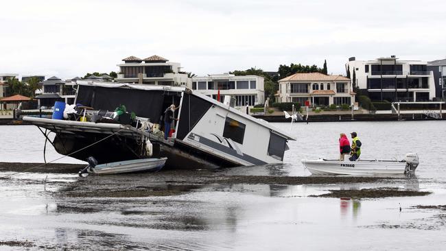 The house boat which sank in Paradise Point. Pictured is the owner on the vessel. Photo:Tertius Pickard