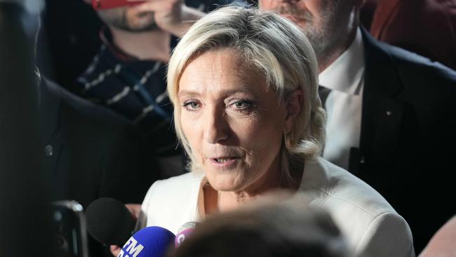 French Rassemblement National (RN) far-right party's leader Marine Le Pen talks to media following the first results of the second round of France's legislative election in Paris.