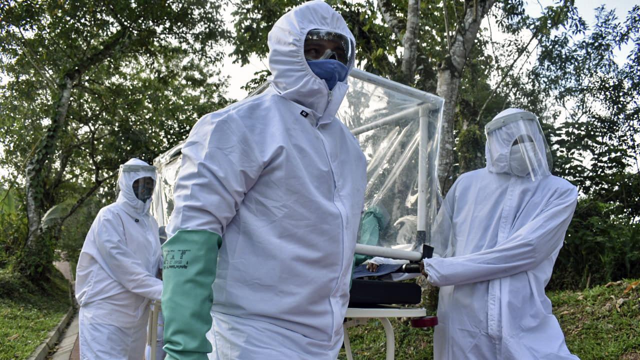 Health workers carry a COVID-19 patient on a stretcher made with pipe tubes and using kitchen gloves in Puerto Carreno, Colombian Amazon, on the border with Peru. Picture: Tatiana de Nevo/AFP