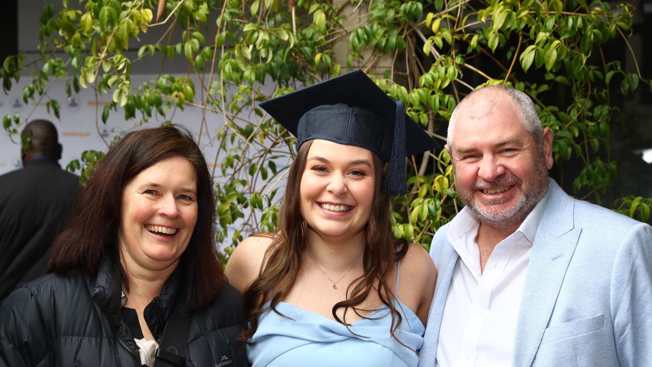 Deakin graduate Jenna Davidson with parents Sherryn and Travis. Picture: Alison Wynd