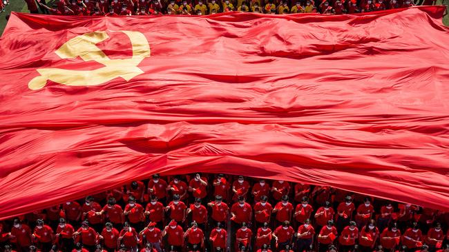 University students displaying the flag of the Communist Party of China to mark the party's 100th anniversary during an opening ceremony of the new semester in Wuhan in China's central Hubei.