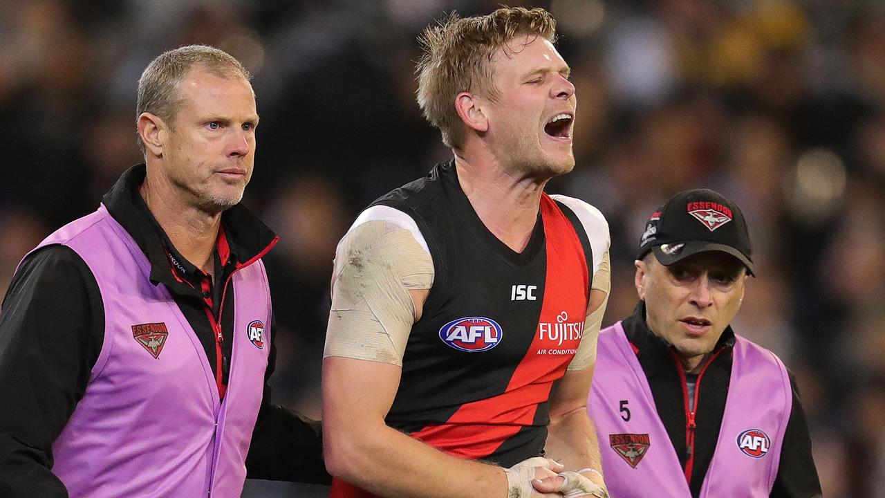 Essendon’s Michael Hurley screams in pain after injuring his shoulder. Picture: Michael Klein