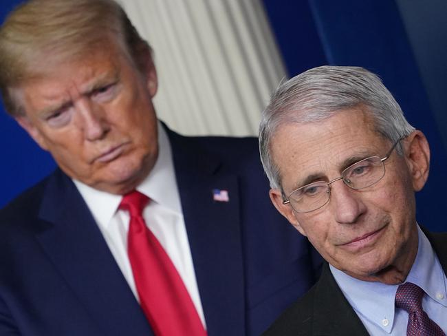 (FILES) In this file photo Director of the National Institute of Allergy and Infectious Diseases Anthony Fauci, flanked by US President Donald Trump, speaks during the daily briefing on the novel coronavirus, which causes COVID-19, in the Brady Briefing Room of the White House on April 22, 2020, in Washington, DC. - US President Donald Trump on May 13 deepened his rift with top medical advisor Anthony Fauci over loosening coronavirus restrictions, saying they "totally" disagree on whether to keep schools closed. (Photo by MANDEL NGAN / AFP) / ALTERNATE CROP