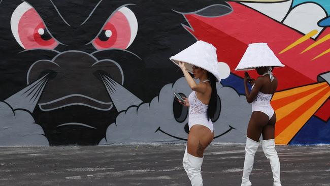 Catherine Lopes (L) and Ebony Smith work to bring attention to the Nightclub E11even, which accepts cryptocurrency payment, at the Bitcoin 2021 Convention. Picture: Joe Raedle/Getty Images/AFP