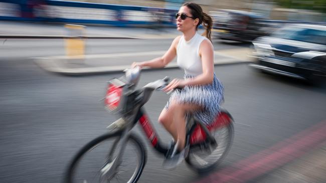 A woman cycles across Tower Bridge during the evening rush hour in London on Wednesday (AEST). Picture: Getty Images