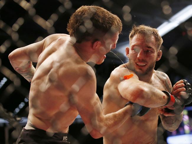 Brad Riddell of New Zealand punches Jamie Mullarkey of Australia and knocks his mouth guard out. (Photo by Darrian Traynor/Getty Images)