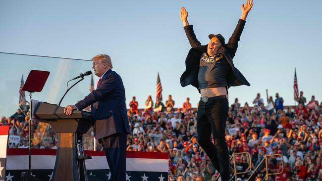 Tesla CEO Elon Musk (R) jumps on stage as he joins former US President and Republican presidential candidate Donald Trump during a campaign rally at site of his first assassination attempt in Butler, Pennsylvania on October 5, 2024. Picture: AFP