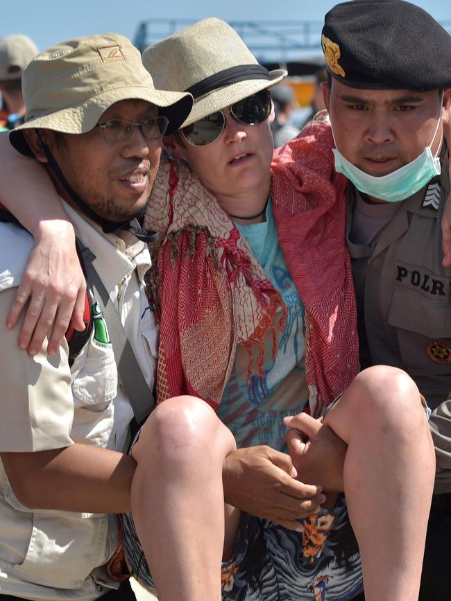 A foreign tourist is given assistance. Picture: Adek Berry/AFP