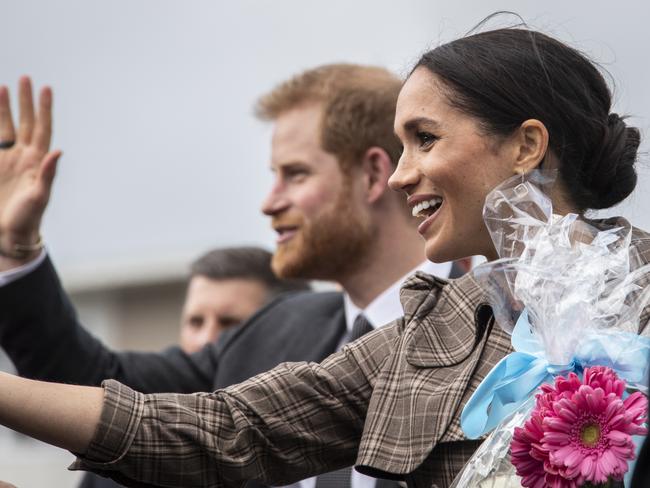 Prince Harry and Meghan Markle greet the crowd at Pukeahu National War Memorial Park. Picture: AAP