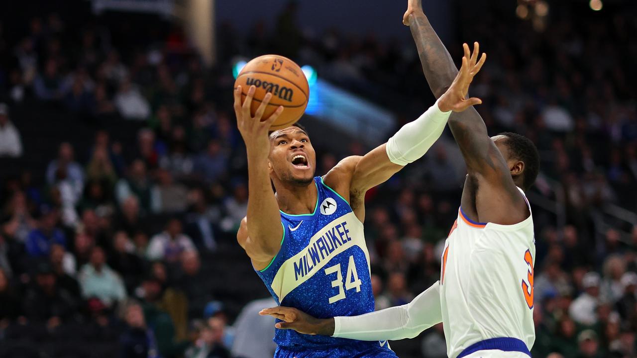 Giannis Antetokounmpo is defended by Julius Randle.  (Photo by Stacy Revere/Getty Images)