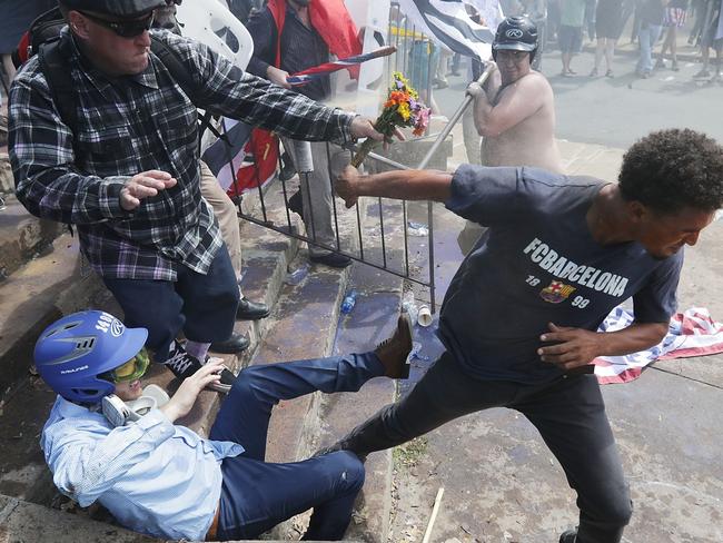 White nationalists, Neo-Nazis and members of the "alt-right" clash with counter-protesters as they attempt to guard the entrance to Lee Park. Picture: Getty