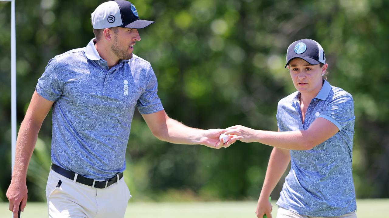 Ash Barty bumps fist with Harry Kane on the 6th hole during day one of the Icons Series. (Photo by Mike Stobe/Getty Images)