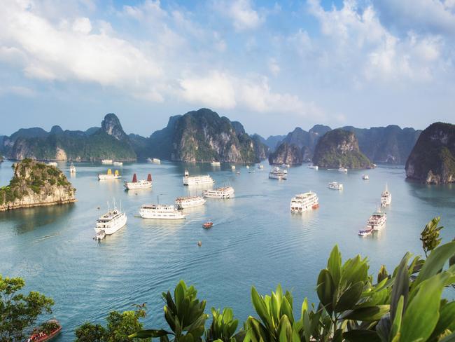 ESCAPE: CRUISING 16 OCTOBER .. Halong Bay Vietnam panorama at sunset with anchored tourist ships photographed from the top of a cliff. Picture: iStock