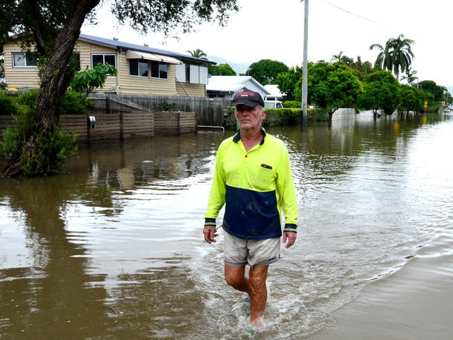 Townsville Floods. Hermit Park resident Ross Cribbin walks through part of Hodel Street still flooded. Picture: Evan Morgan