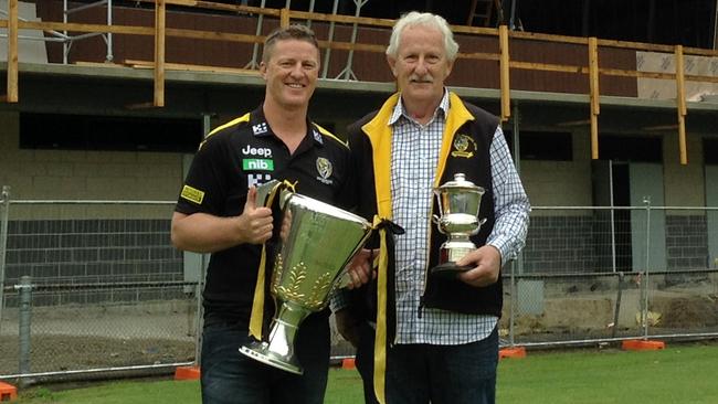 Richmond coach Damien Hardwick with the 2017 premiership cup and father Noel Hardwick with the 1989 Under 17s premiership cup at the Tigers' coach's junior club Upwey Tecoma. Picture: Supplied