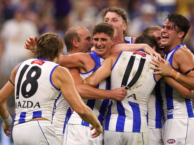 PERTH, AUSTRALIA - MARCH 25: The Kangaroos celebrate winning the round 2 AFL match between the Fremantle Dockers and North Melbourne Kangaroos at Optus Stadium, on March 25, 2023, in Perth, Australia. (Photo by Paul Kane/Getty Images)