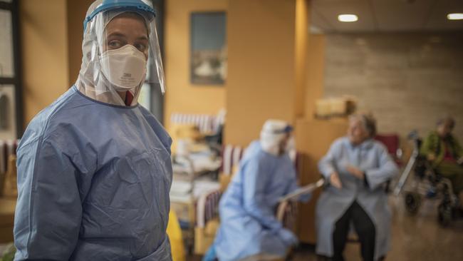 InSoain, aid workers from the Spanish NGO Open Arms carry out coronavirus detection tests on the elderly at a nursing home in Barcelona. Picture: Santi Palacios/AP