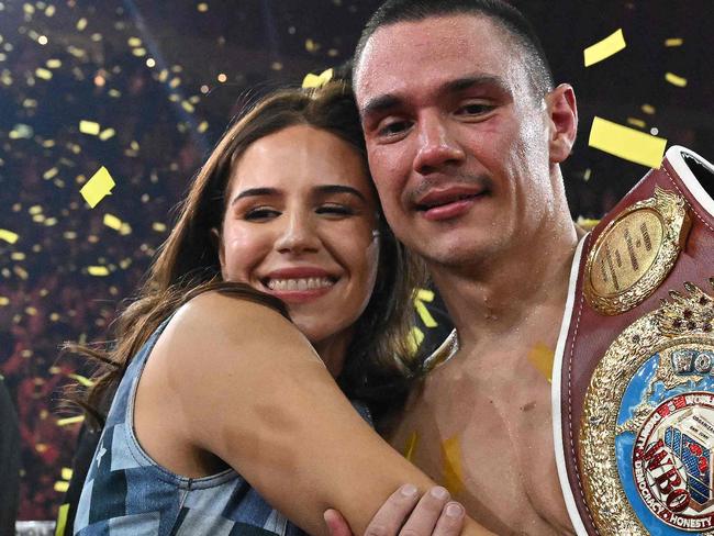 Australian boxer Tim Tszyu (R) celebrates with his partner Alexandra Constantine following his victory over USA's Tony Harrison in their WBO super welterweight world title bout at Qudos Bank Arena in Sydney on March 12, 2023. (Photo by Saeed KHAN / AFP) / -- IMAGE RESTRICTED TO EDITORIAL USE - STRICTLY NO COMMERCIAL USE --