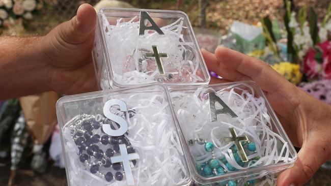 A sea of rosary beads and bouquets have filled Oatlands site where four children died. Picture: John Grainger